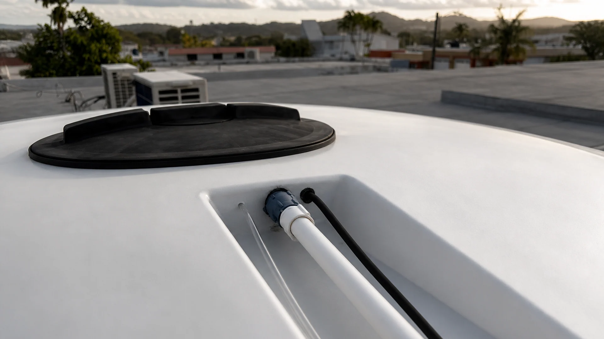 Professional Auctus cistern-monitoring installation with enclosure, sensing line, and plumbing connection.