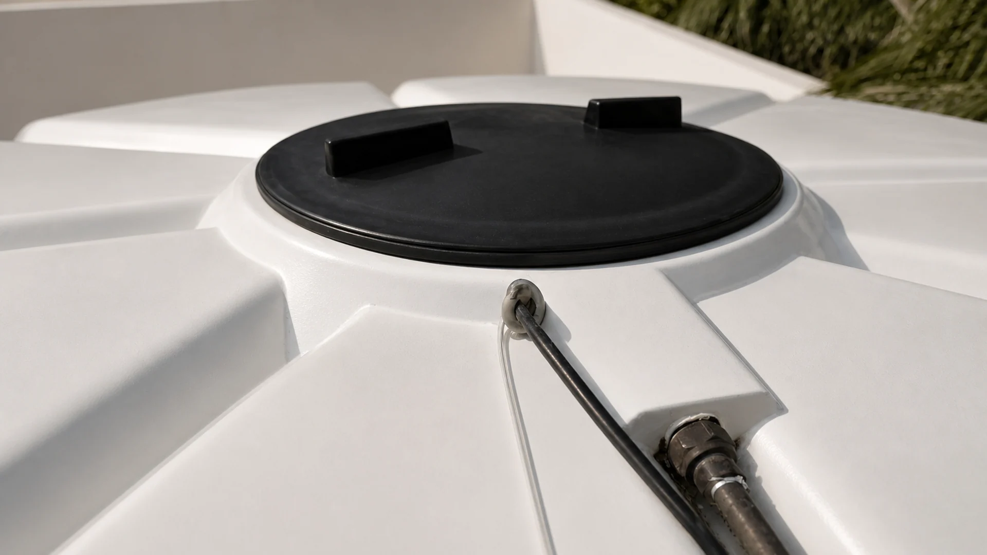 Installed Auctus cistern-monitoring enclosure secured to a black water tank.